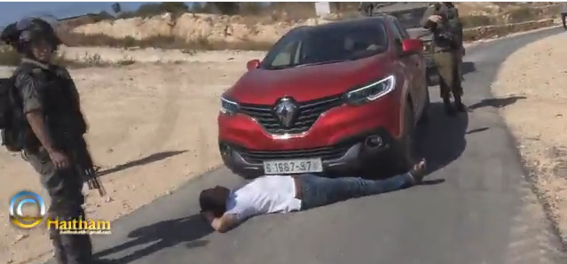 Mohammad Khatib lying in front of his car (image by Haitham Khatib)