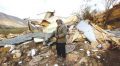 Palestinian man next to his demolished home this week (PCHR photo)