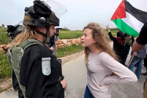 Ahed confronting an Israeli soldier at a protest