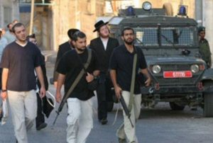 Armed Israeli settlers invading Hebron (archive image - source: ISM)