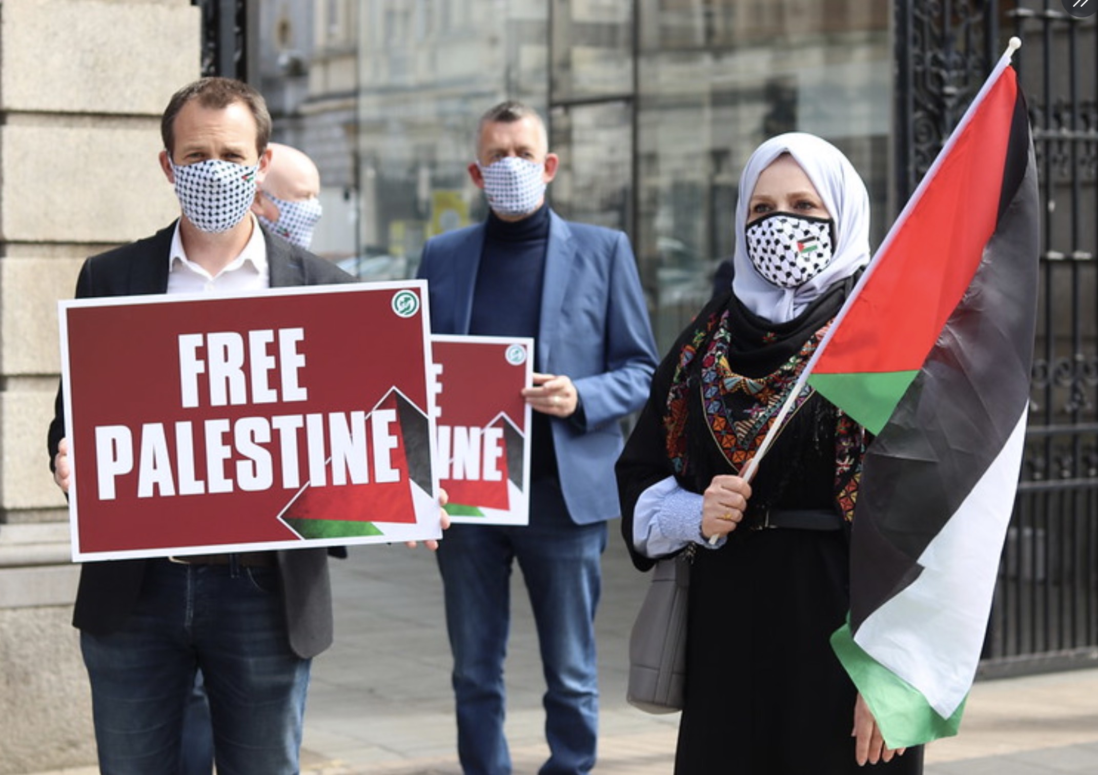 People hold palestinian flags and "free Palestine" signs Irish government shows solidarity with Palestinians in a historic motion to condemn Israeli settlement activity as defect annexation. photo credited to @sinnfeinireland