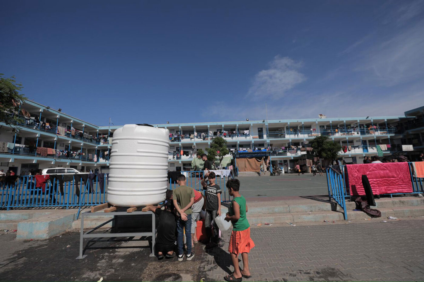 Children getting water at a United Nations school-turned-shelter in Gaza