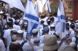 Scene from June 6th Flag March in Jerusalem,a yearly event in which extremist settlers often harass Palestinians along their route.