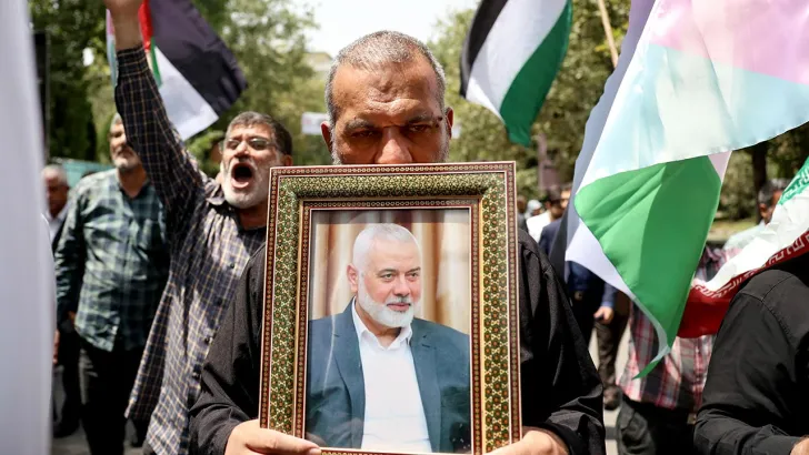An Iranian man holds a picture of Palestinian group Hamas' top leader Ismail Haniyeh, during a gathering following Haniyeh's killing, amid the ongoing conflict between Israel and Hamas, in Tehran, Iran July 31, 2024. (ABEDIN TAHERKENAREH/EPA-EFE/Shutterstock)